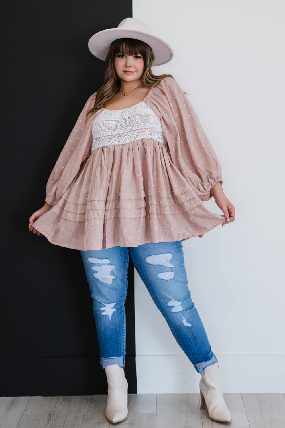 A feminine polka dot blouse featuring a lace yoke, balloon sleeves, and ruffle details, perfect for various occasions.