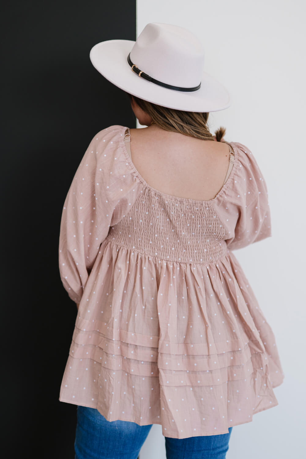 A feminine polka dot blouse featuring a lace yoke, balloon sleeves, and ruffle details, perfect for various occasions.