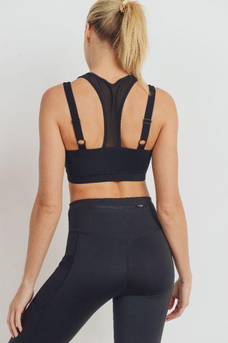 Harness Mesh Hybrid Racerback Sports Bra featuring a mesh front and adjustable straps, made from recycled materials.