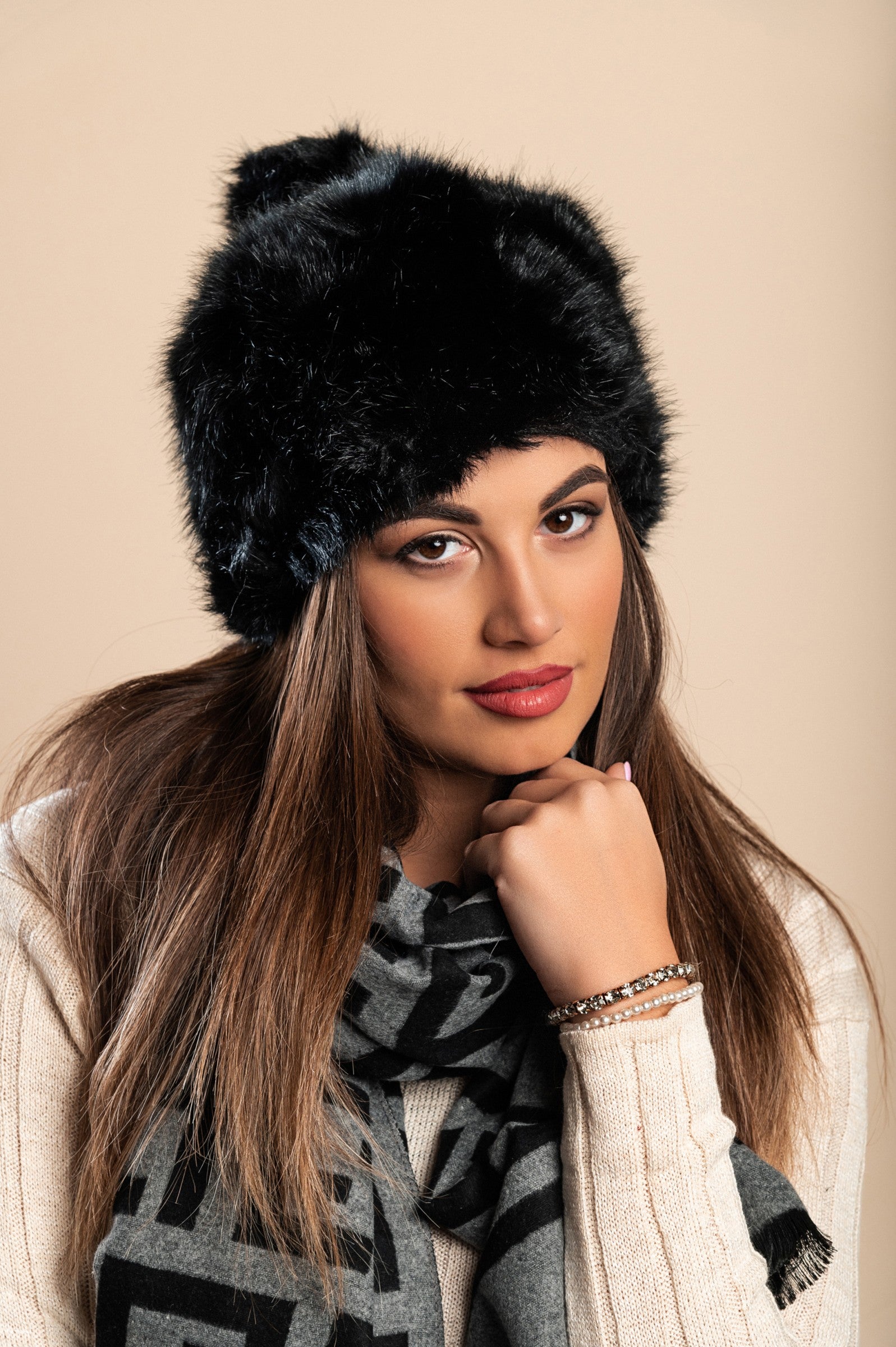 Elegant black hat with synthetic fur, showcasing its luxurious texture and stylish design.