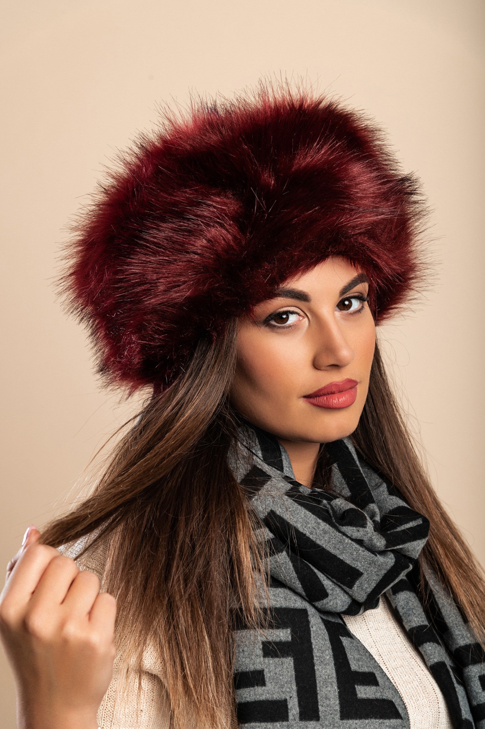 Elegant burgundy hat made of synthetic fur, showcasing a soft texture and stylish design.