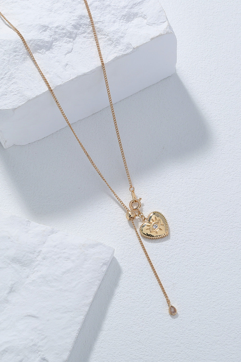 A beautiful Heart Pendant Drop Necklace featuring lustrous rhinestones on a brass chain, showcasing elegance and charm.