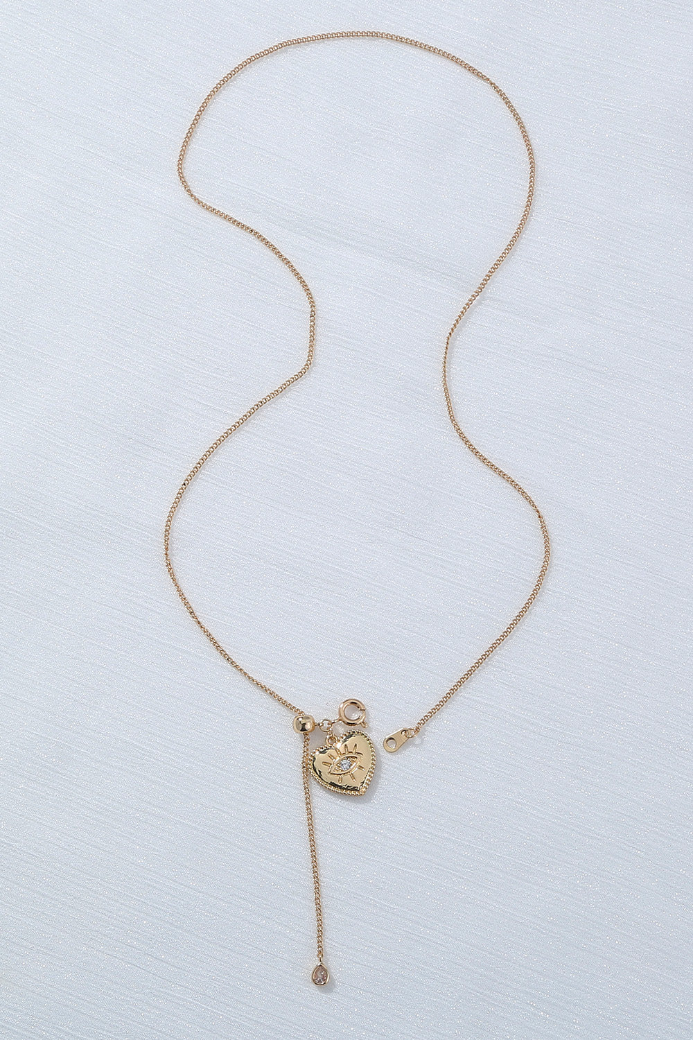 A beautiful Heart Pendant Drop Necklace featuring lustrous rhinestones on a brass chain, showcasing elegance and charm.