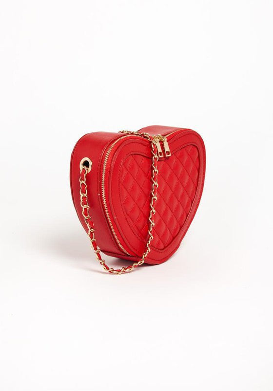 A stylish heart shaped crossbody bag with a textured quilted pattern and gold tone chain strap, perfect for evening events.