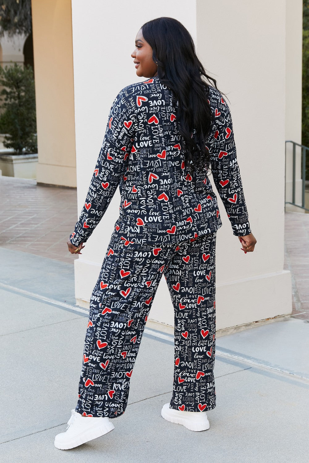 Heimish Full Size LOVE Heart Lounge Pants displayed outdoors, featuring a stylish printed pattern and comfortable fit.