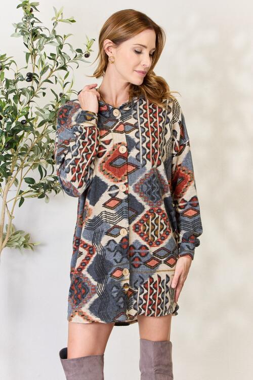 Heimish Full Size Printed Button Up Hooded Jacket featuring a vibrant multi-color print and long puff sleeves, perfect for stylish layering.