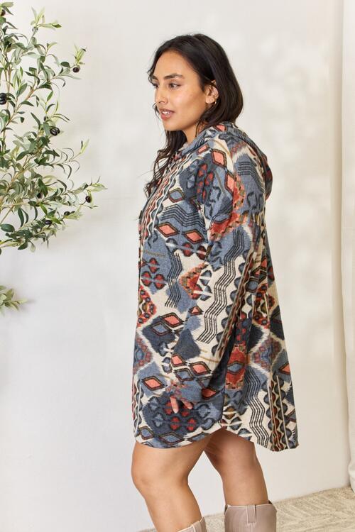 Heimish Full Size Printed Button Up Hooded Jacket featuring a vibrant multi-color print and long puff sleeves, perfect for stylish layering.