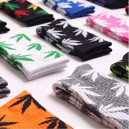 A pair of soft cotton socks featuring a vibrant hemp leaf design, perfect for cannabis enthusiasts.