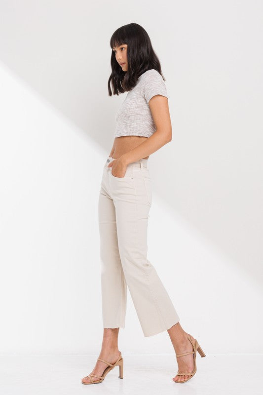 High Rise Cropped Kick Flare jeans with raw scissor cut hem, displayed on a model standing 5'11" wearing size 26.