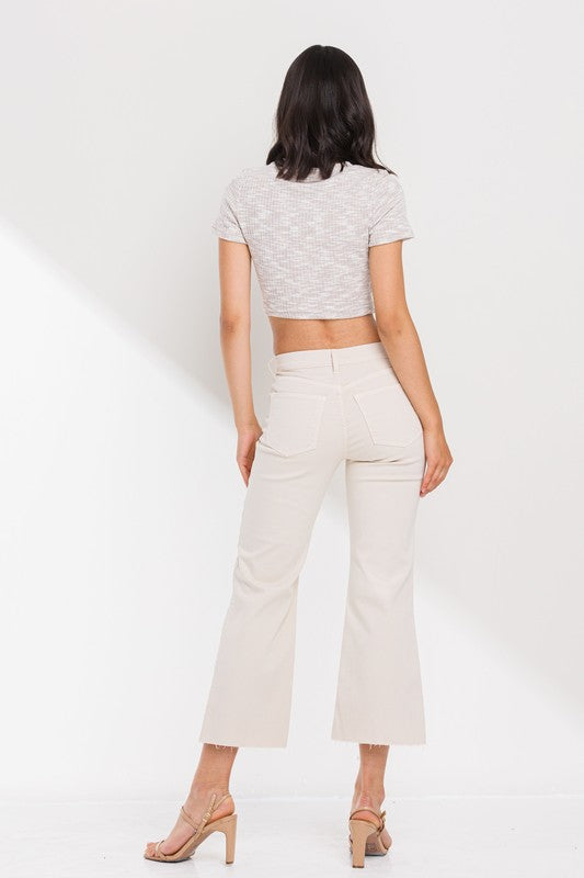 High Rise Cropped Kick Flare jeans with raw scissor cut hem, displayed on a model standing 5'11" wearing size 26.