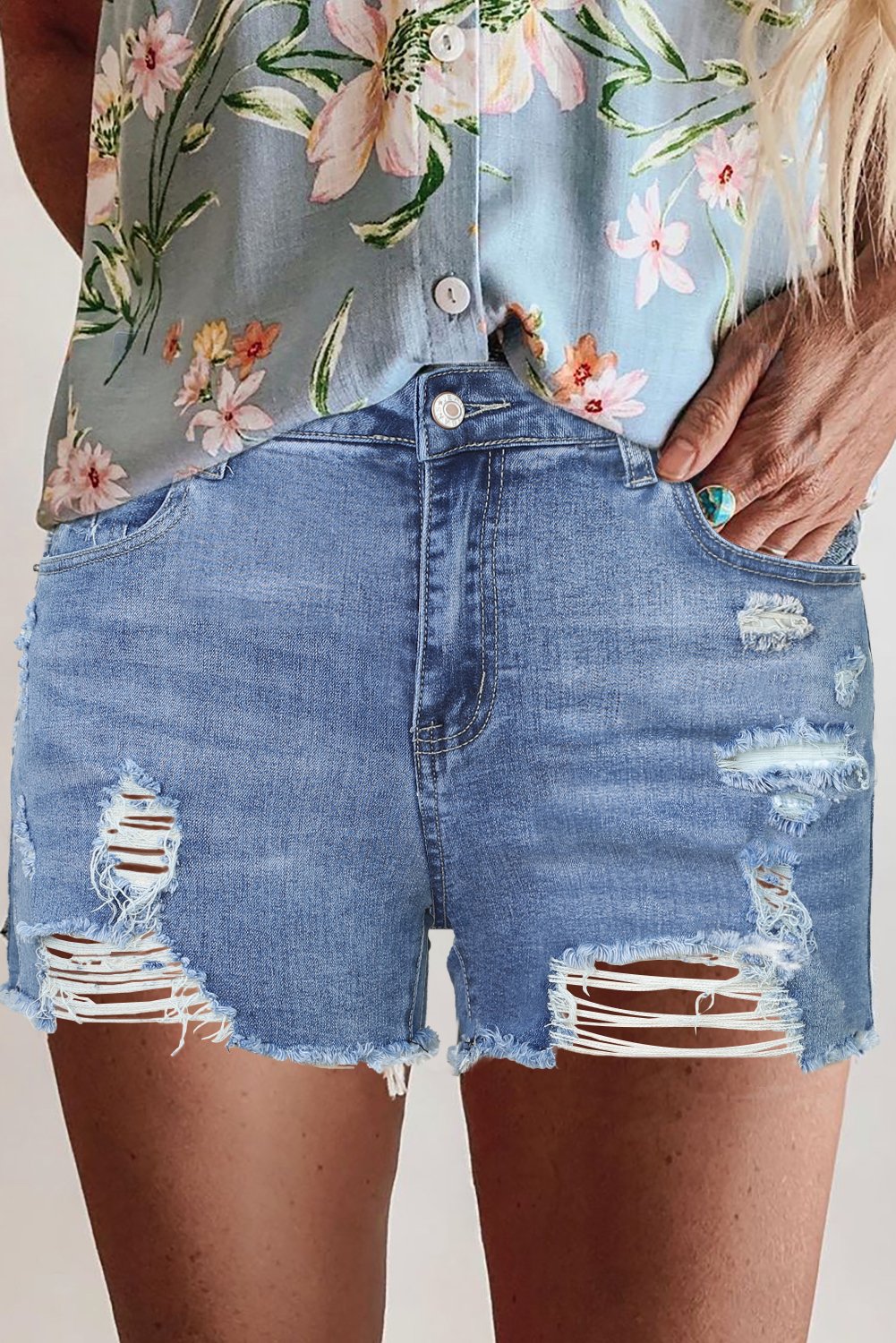 High Rise Destroyed Denim Shorts featuring heavy distressing and a high waist design, perfect for summer fashion.