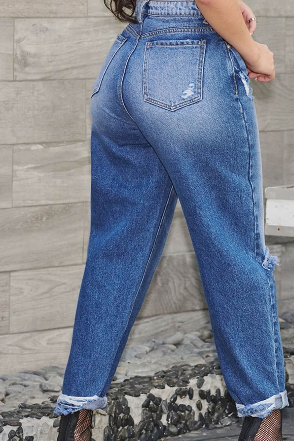 High Waist Distressed Tapered Jeans displayed in a studio setting, showcasing the distressed details and tapered fit.