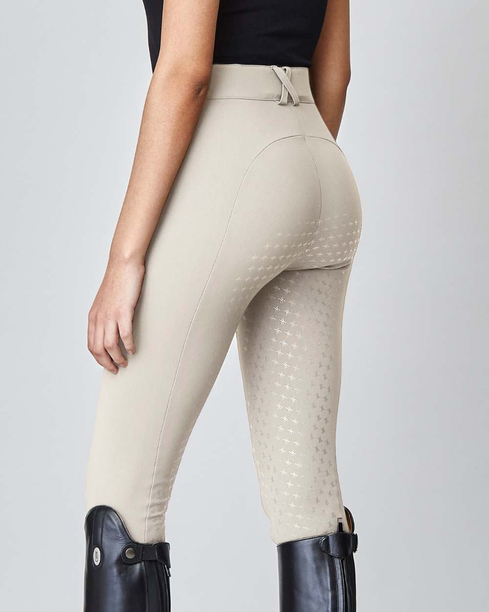 High-Rise Compression Breeches in Tan, featuring a high waist, zipper, and belt loops, made from lightweight Italian jersey fabric.