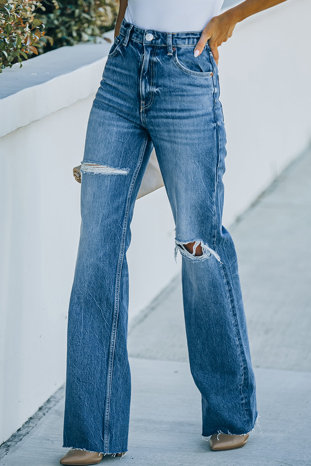 High-Rise Distressed Raw Hem Jeans featuring a chic design with a raw hem and distressed details, made from a comfortable cotton blend.