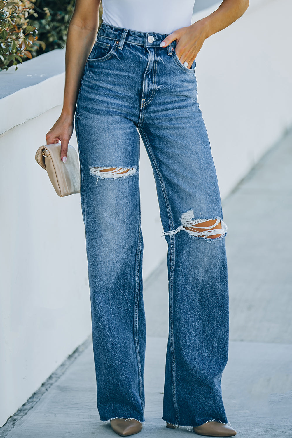 High-Rise Distressed Raw Hem Jeans featuring a chic design with a raw hem and distressed details, made from a comfortable cotton blend.