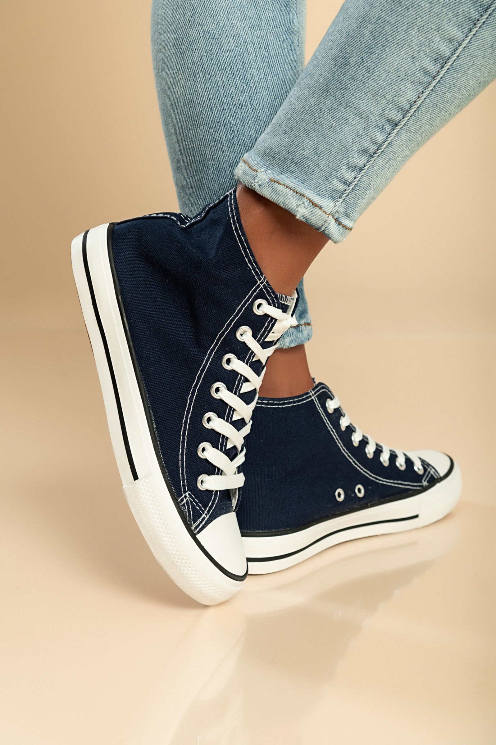 Dark blue high-top canvas sneakers with lace-up fastening and round plastic toe, showcasing a stylish and comfortable design.