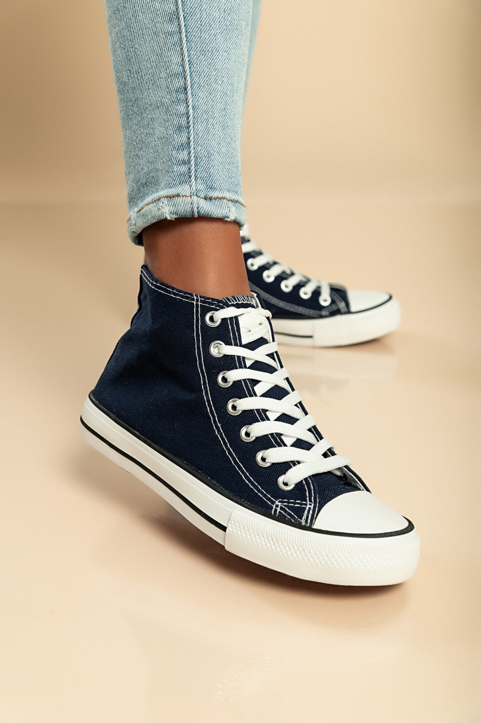 Dark blue high-top canvas sneakers with lace-up fastening and round plastic toe, showcasing a stylish and comfortable design.