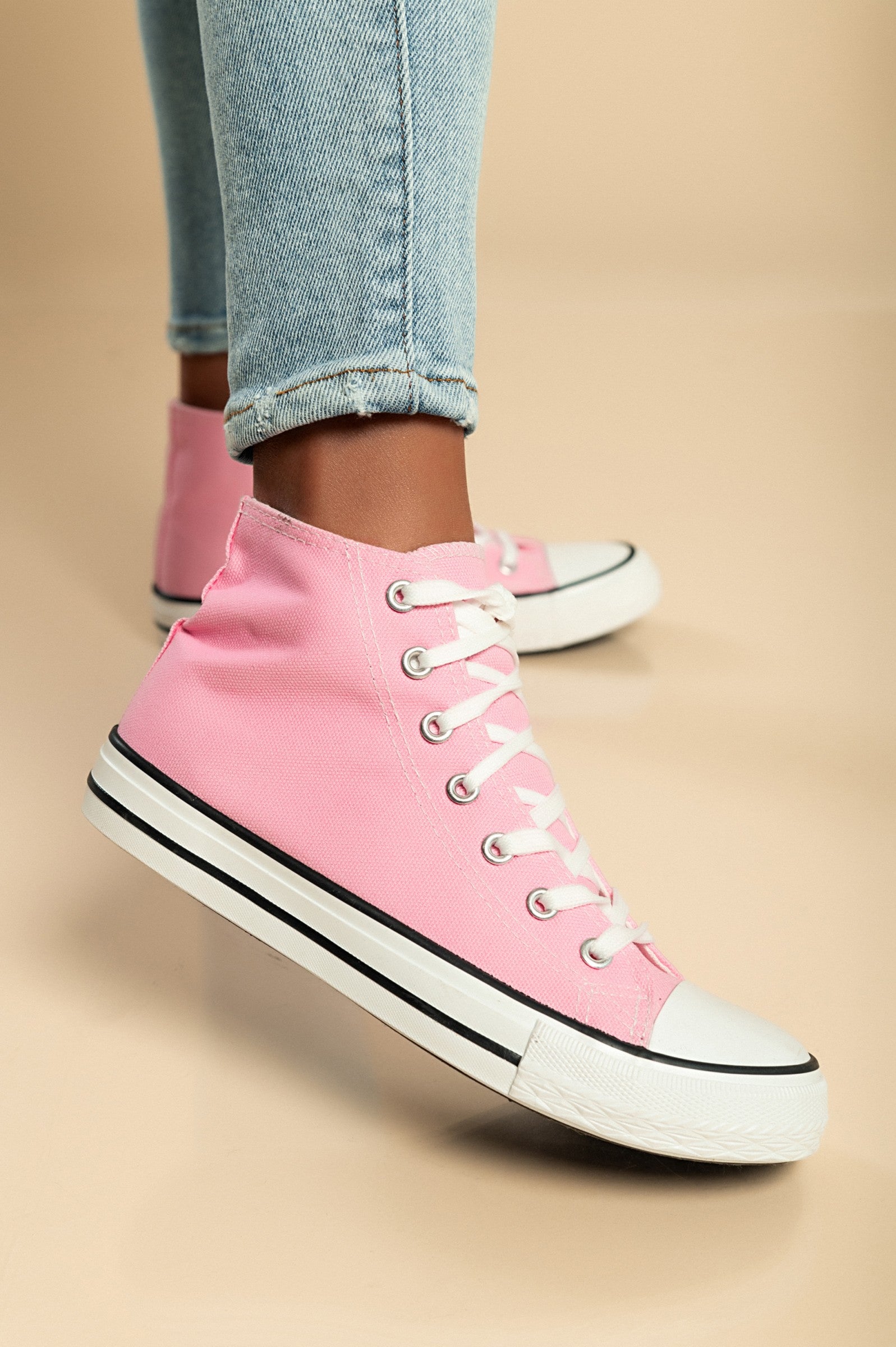 Pink high-top canvas sneakers featuring a round plastic toe and lace-up fastening, perfect for stylish comfort.