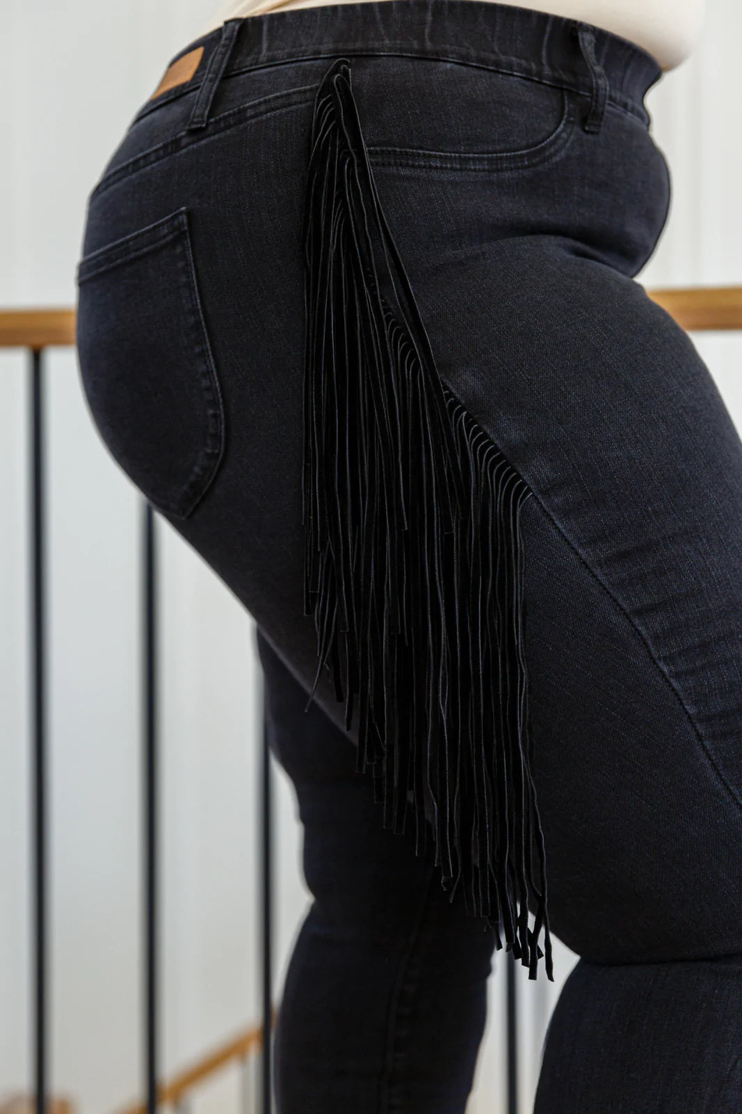 Hilary Side Fringe Skinny Jegging in Black featuring faux suede fringe on the sides, mid-rise waist, and skinny fit.