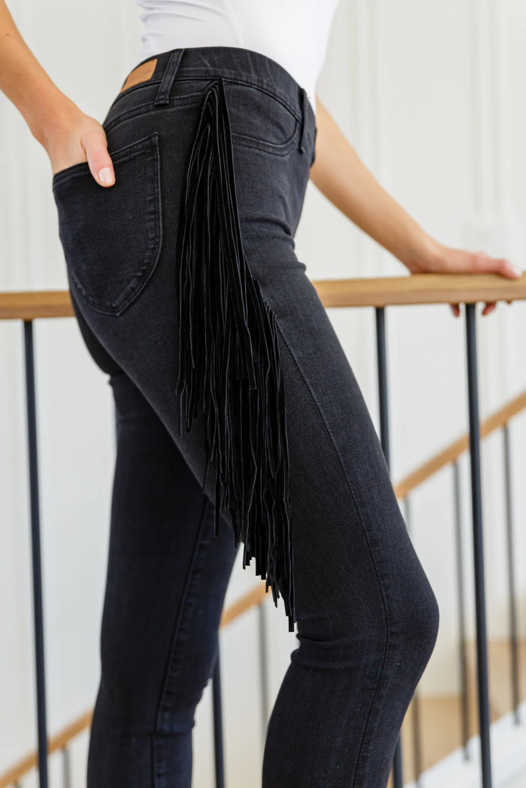 Hilary Side Fringe Skinny Jegging in Black featuring faux suede fringe on the sides, mid-rise waist, and skinny fit.