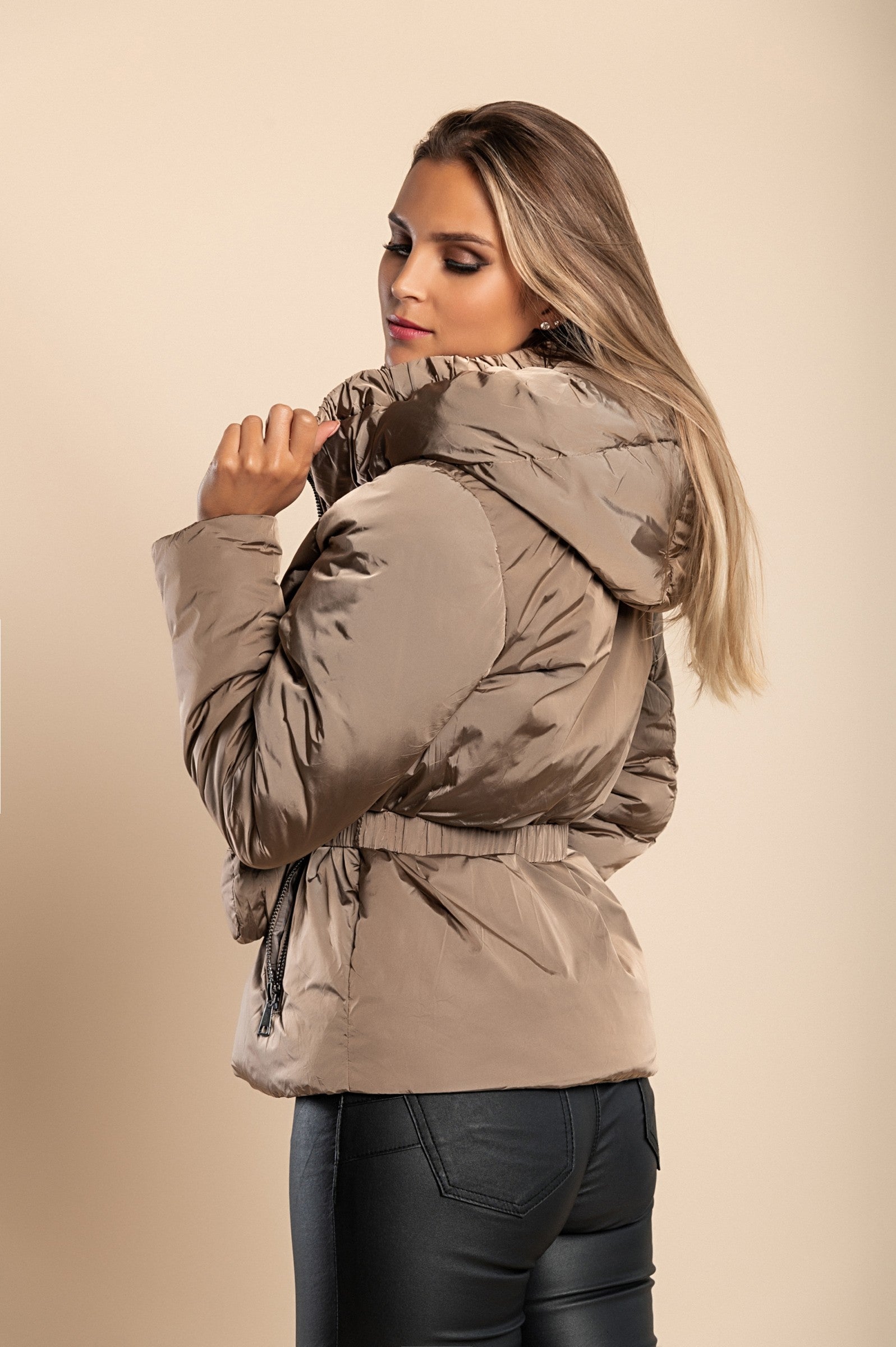 Beige hooded jacket with warm padding, high collar, and side zipper pockets, featuring an elastic belt with a bag.