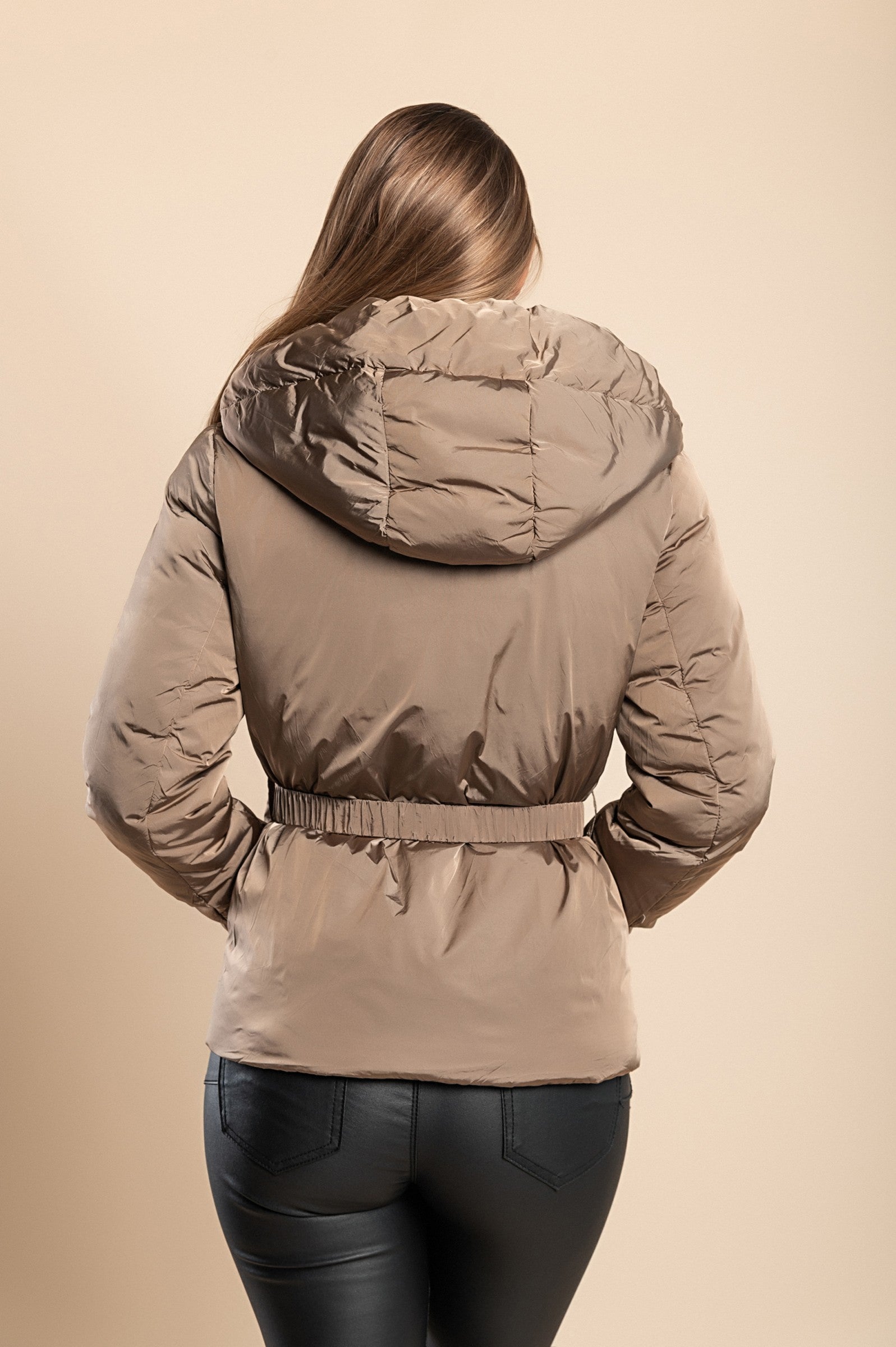 Beige hooded jacket with warm padding, high collar, and side zipper pockets, featuring an elastic belt with a bag.