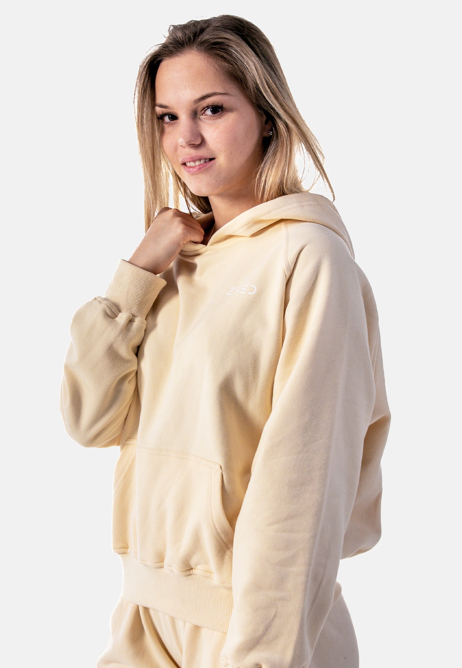 Stylish yellow women's hoodie with a cozy lined pocket and loose fit, perfect for casual wear and relaxation.