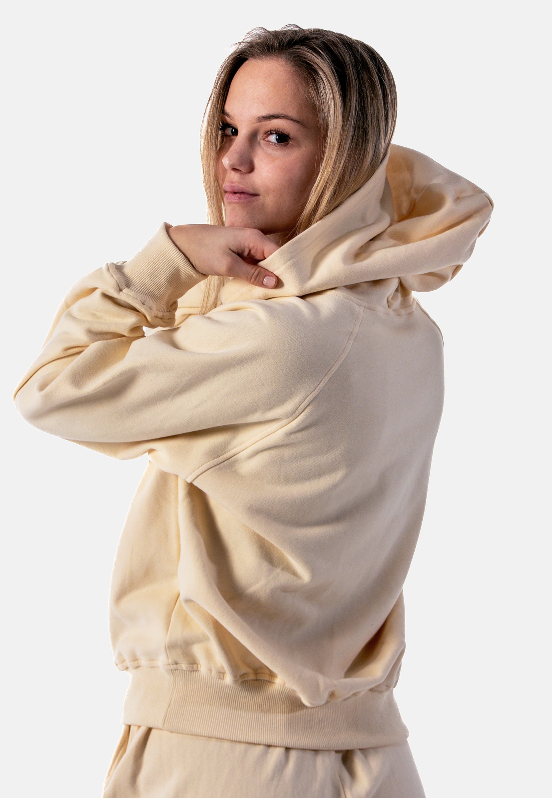 Stylish yellow women's hoodie with a cozy lined pocket and loose fit, perfect for casual wear and relaxation.