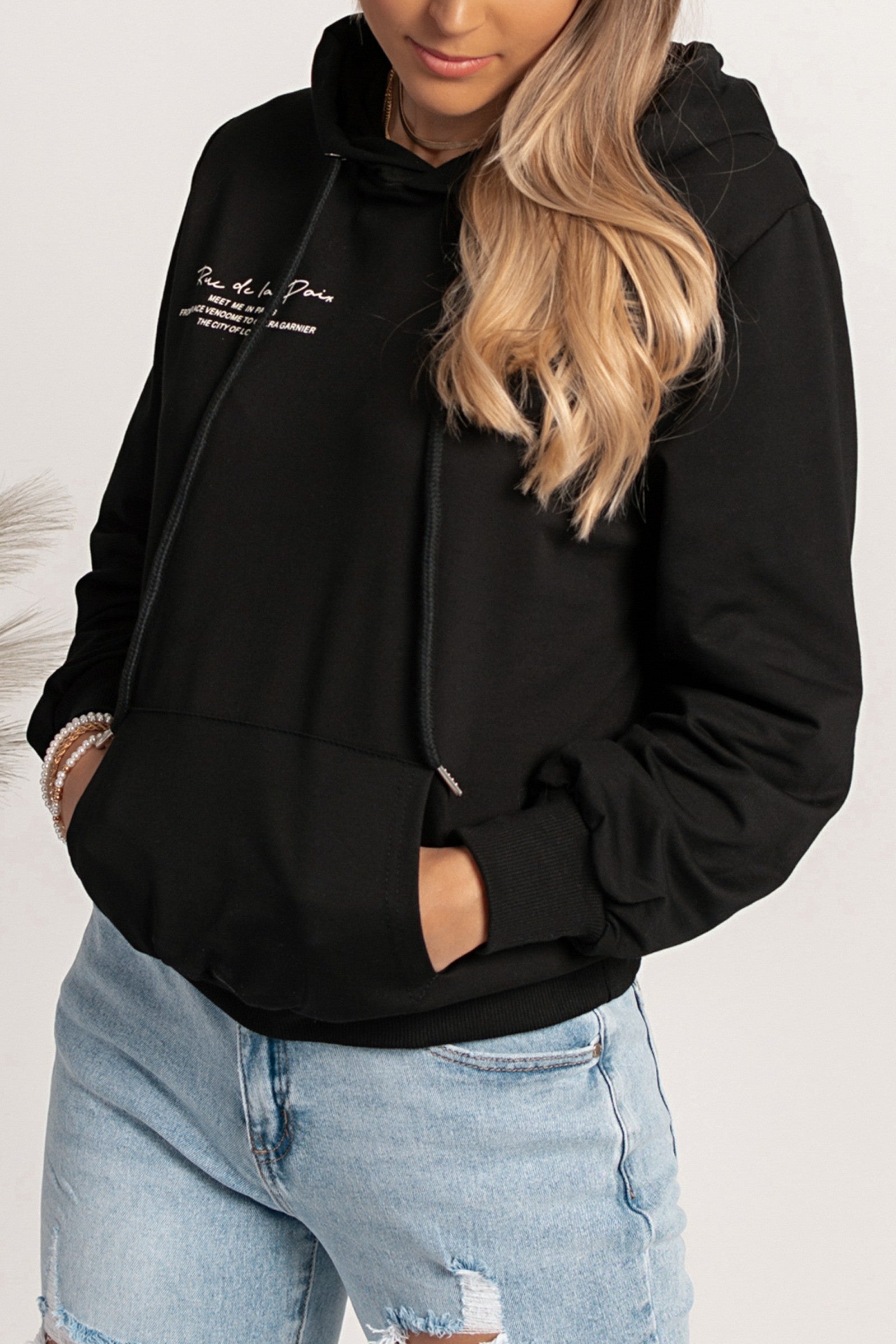 Black Rapalla hoodie featuring a front print, drawstring hood, and front pocket, made from a comfortable cotton-polyester blend.