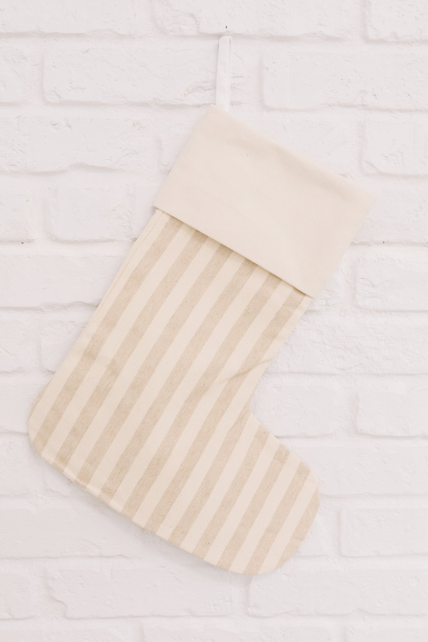 Neutral colored Holiday Chic Stocking with a hanging loop, perfect for festive decor.