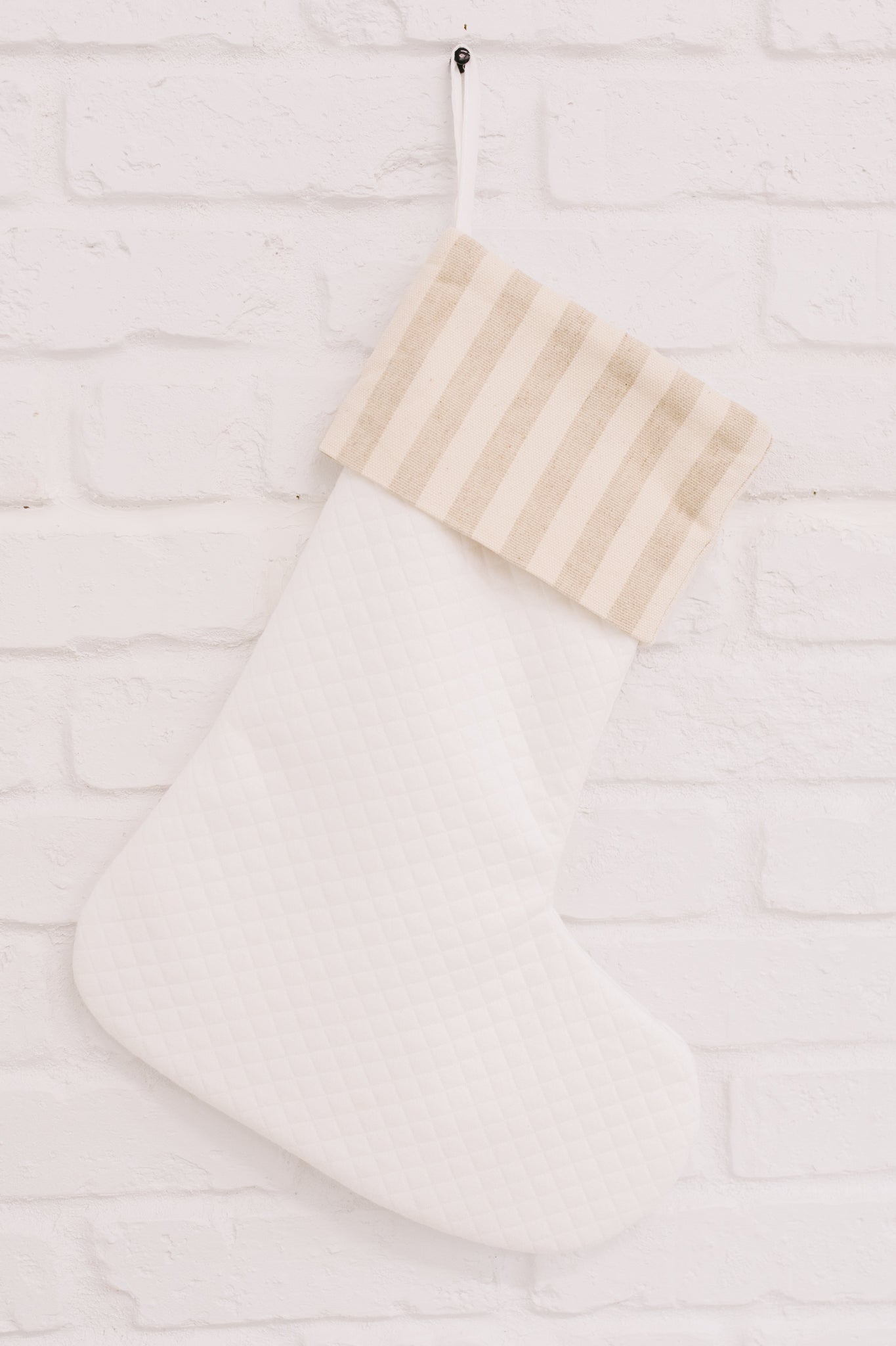 Neutral colored Holiday Chic Stocking with a hanging loop, perfect for festive decor.