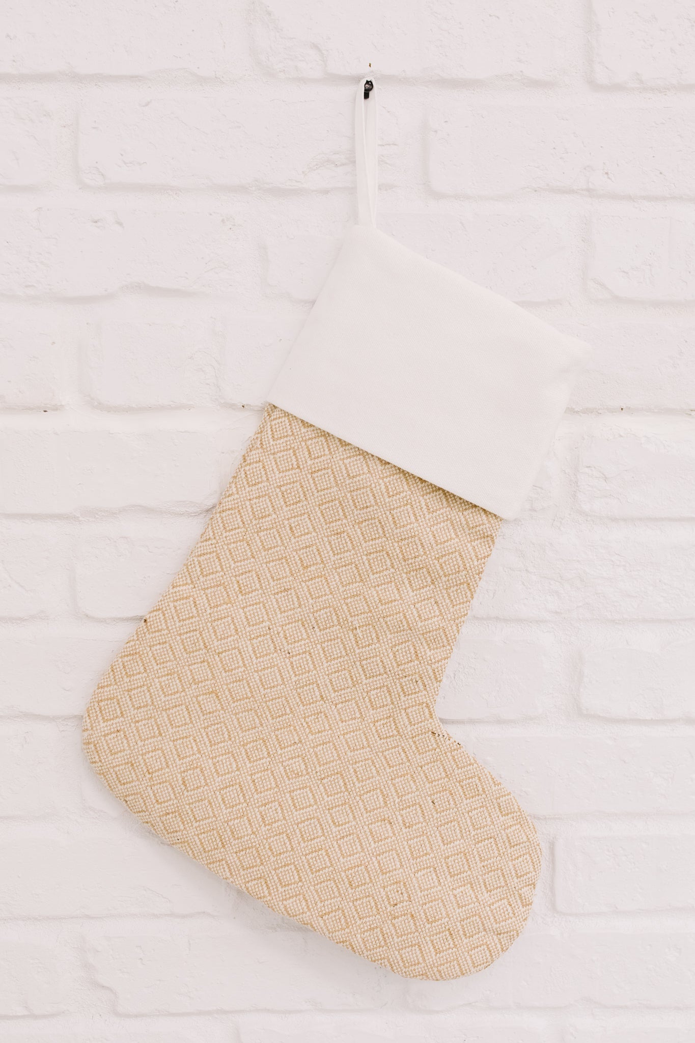 Neutral colored Holiday Chic Stocking with a hanging loop, perfect for festive decor.