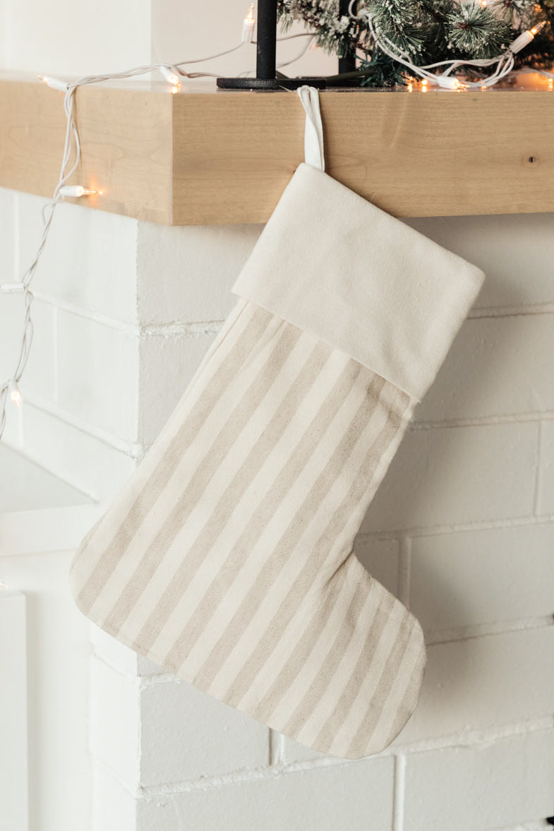 Neutral colored Holiday Chic Stocking with a hanging loop, perfect for festive decor.