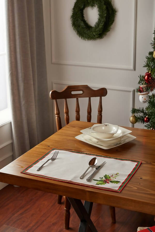 Holly Berry and Greenery Pattern Placemats on an ivory background, featuring a festive holiday design with traditional colors.