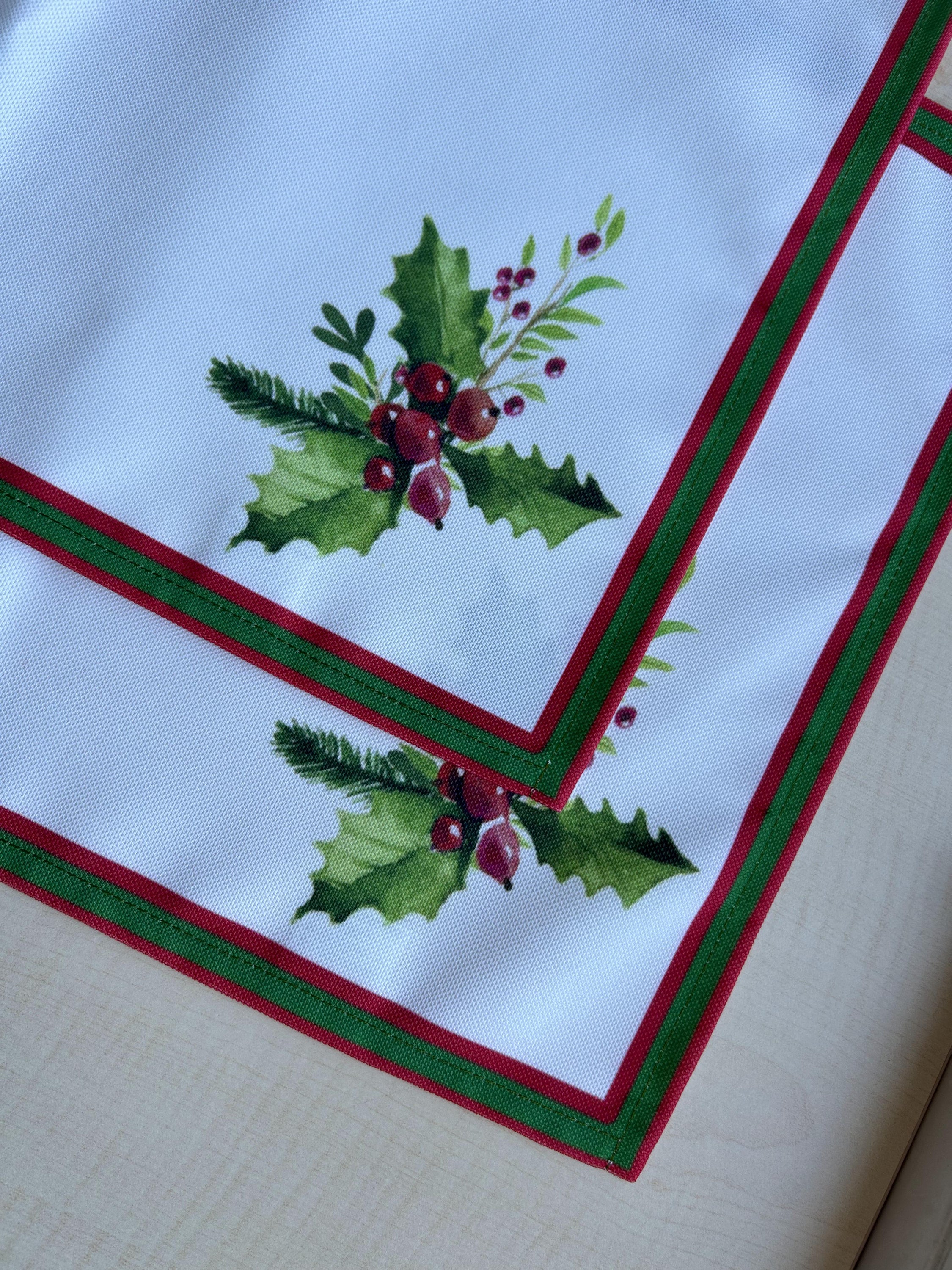 Holly Berry and Greenery Pattern Placemats on an ivory background, featuring a festive holiday design with traditional colors.