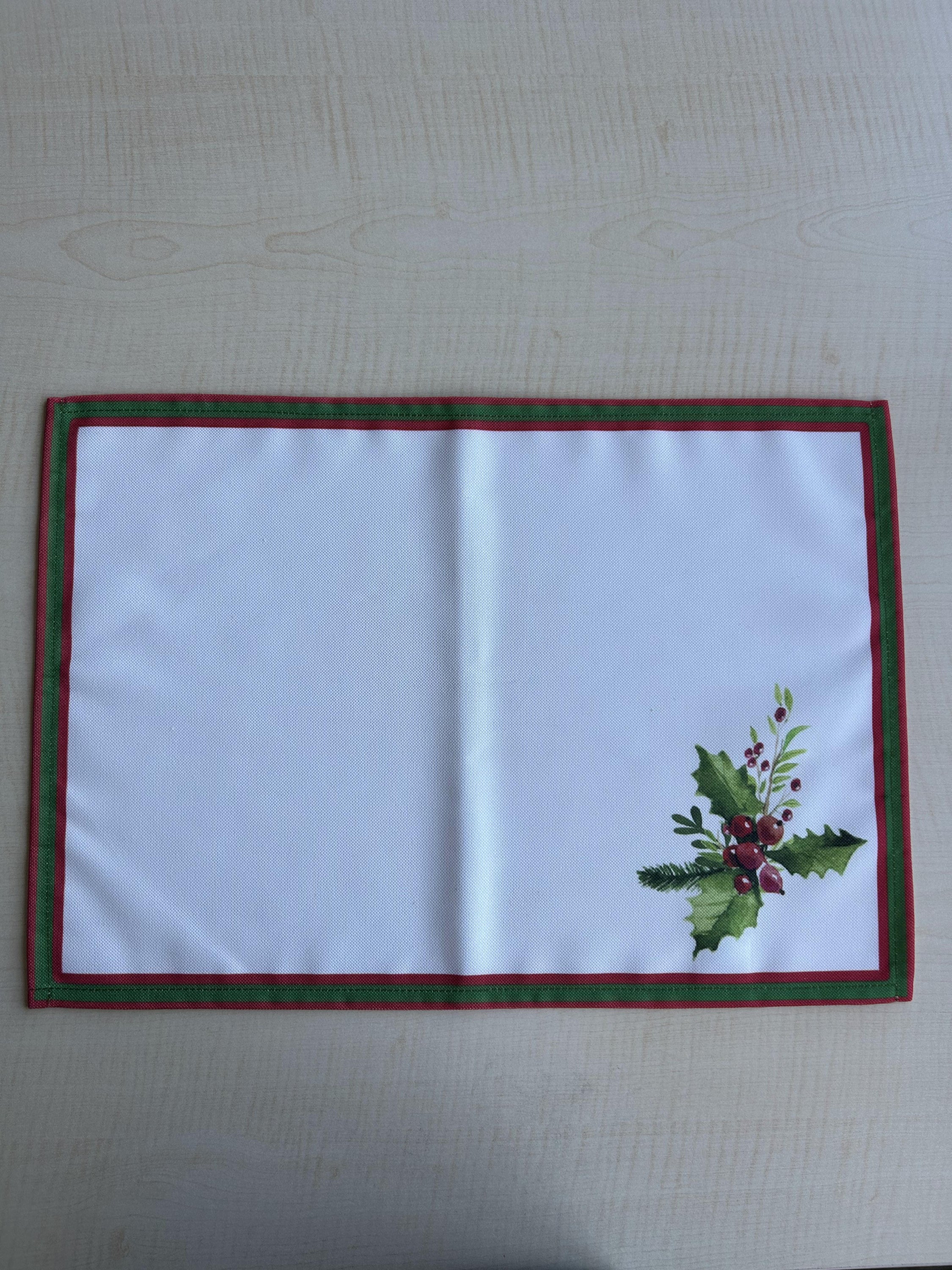 Holly Berry and Greenery Pattern Placemats on an ivory background, featuring a festive holiday design with traditional colors.