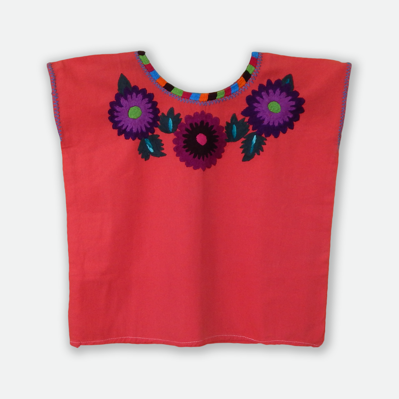 A vibrant Huipil blouse featuring colorful embroidered flowers, handcrafted by artisans from Oaxaca, Mexico, showcasing intricate designs and cultural significance.