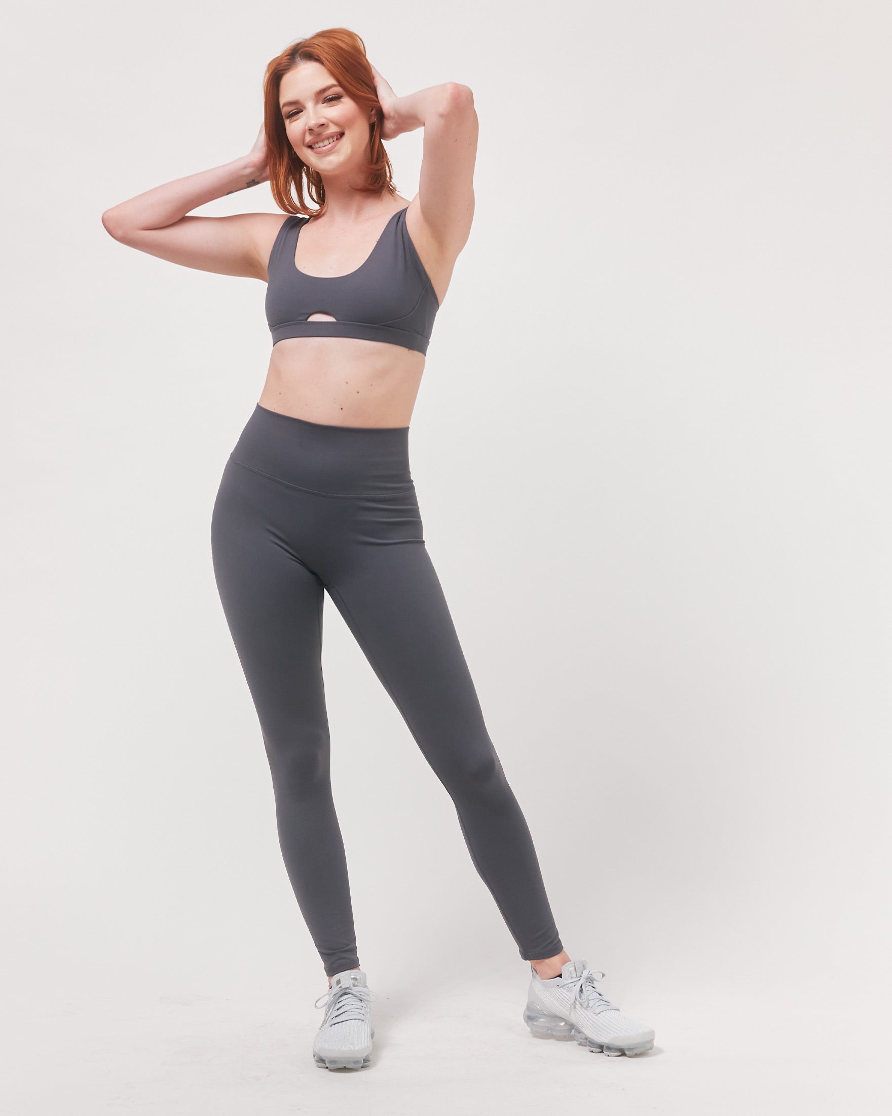 A pair of black Hybrid Cloudlux Leggings with a high waist and seamless design, showcasing V-shaped seams at the back for a flattering fit.