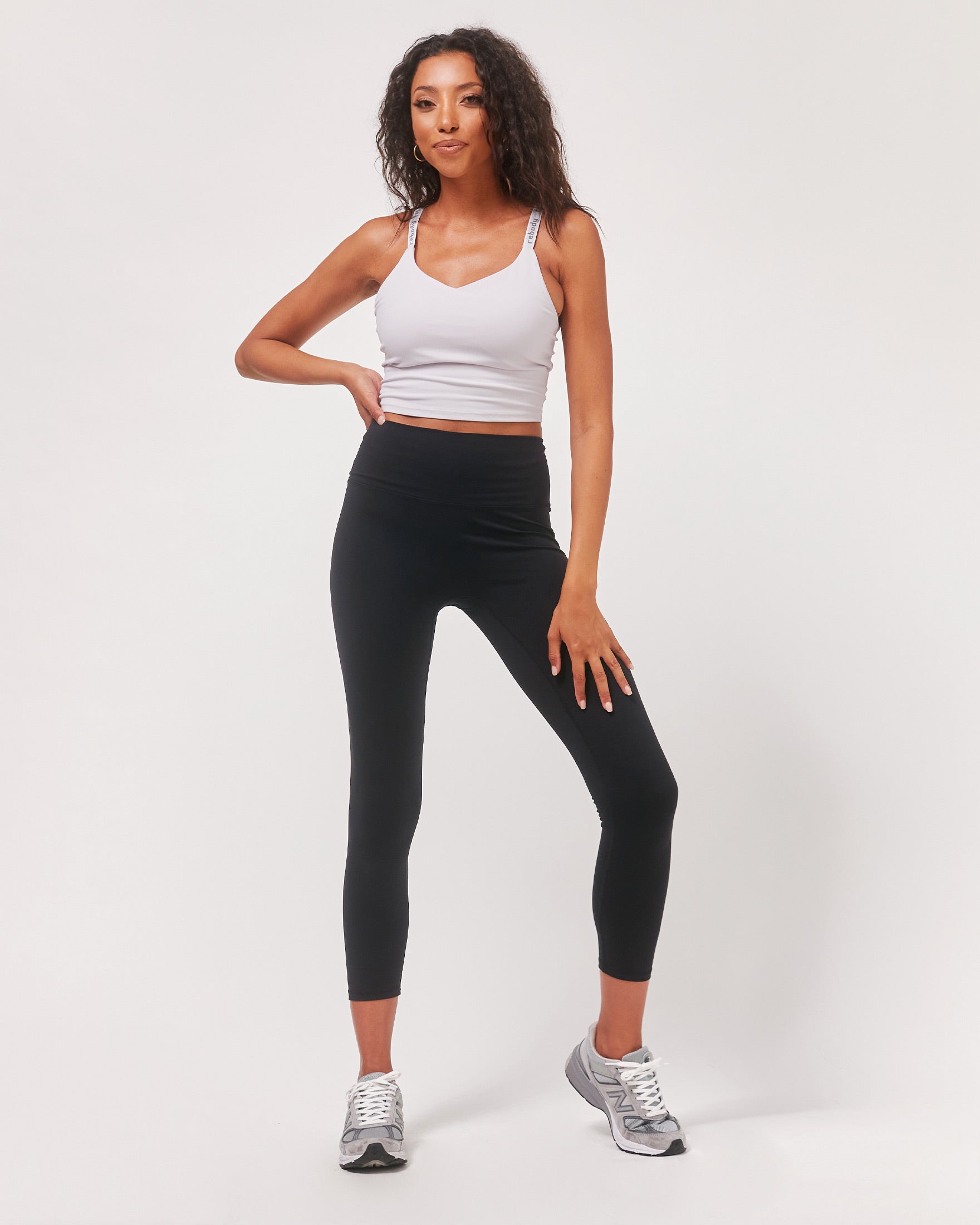 A pair of black Hybrid Cloudlux Leggings with a high waist and seamless design, showcasing V-shaped seams at the back for a flattering fit.