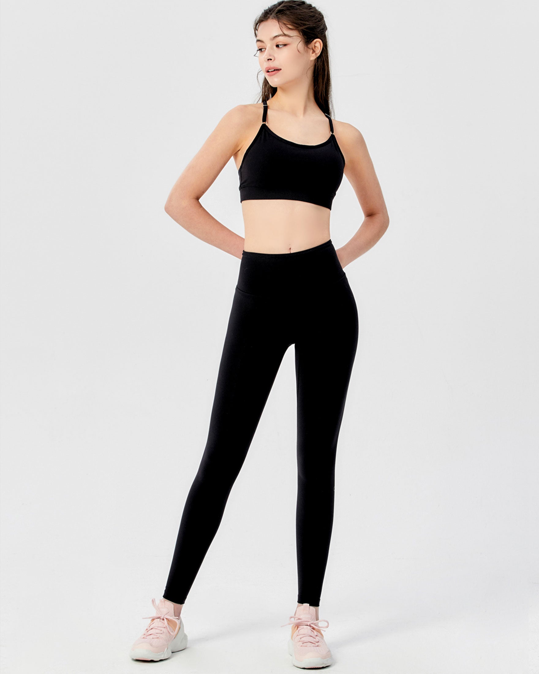 A pair of black Hybrid Cloudlux Leggings with a high waist and seamless design, showcasing V-shaped seams at the back for a flattering fit.