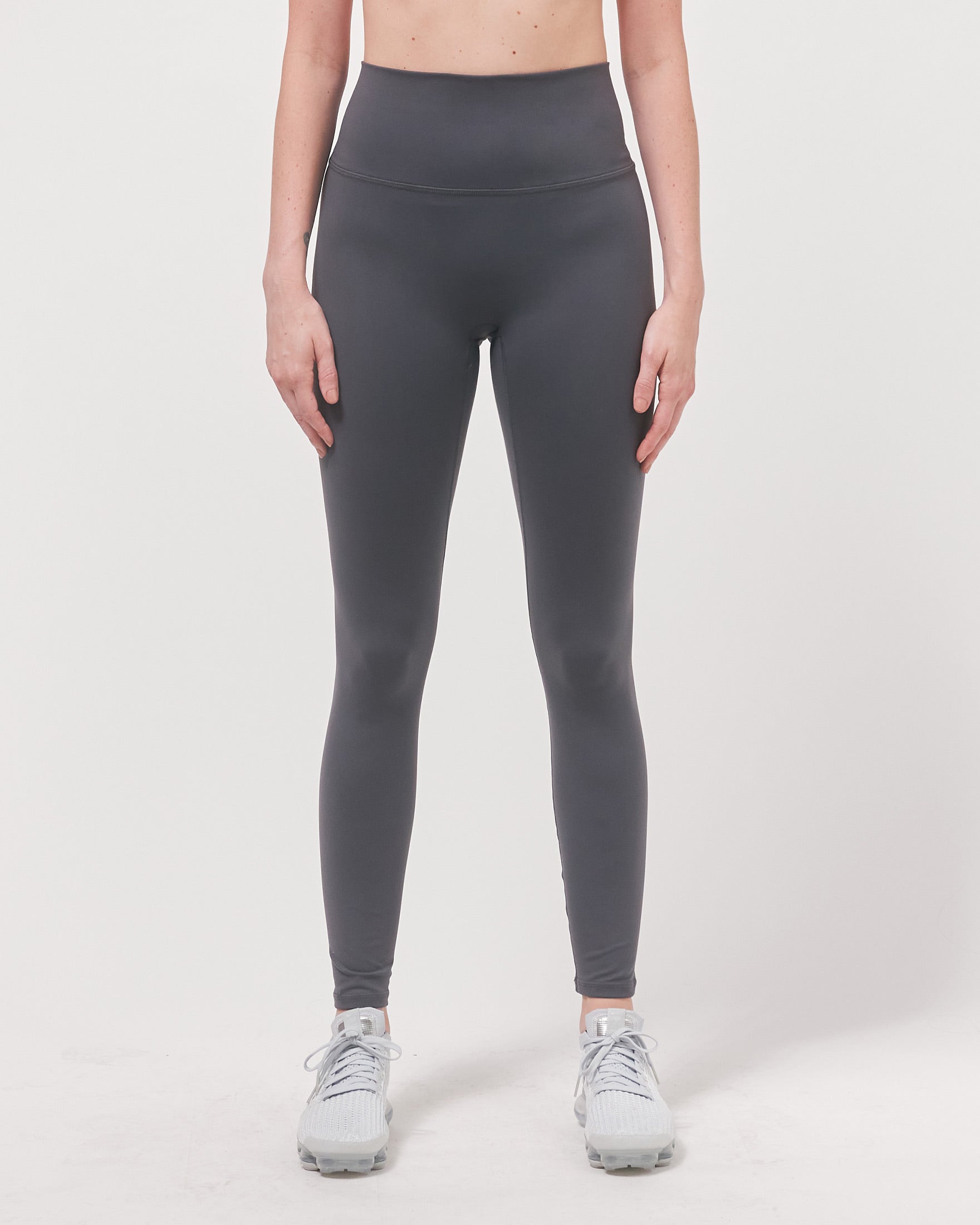 A pair of black Hybrid Cloudlux Leggings with a high waist and seamless design, showcasing V-shaped seams at the back for a flattering fit.