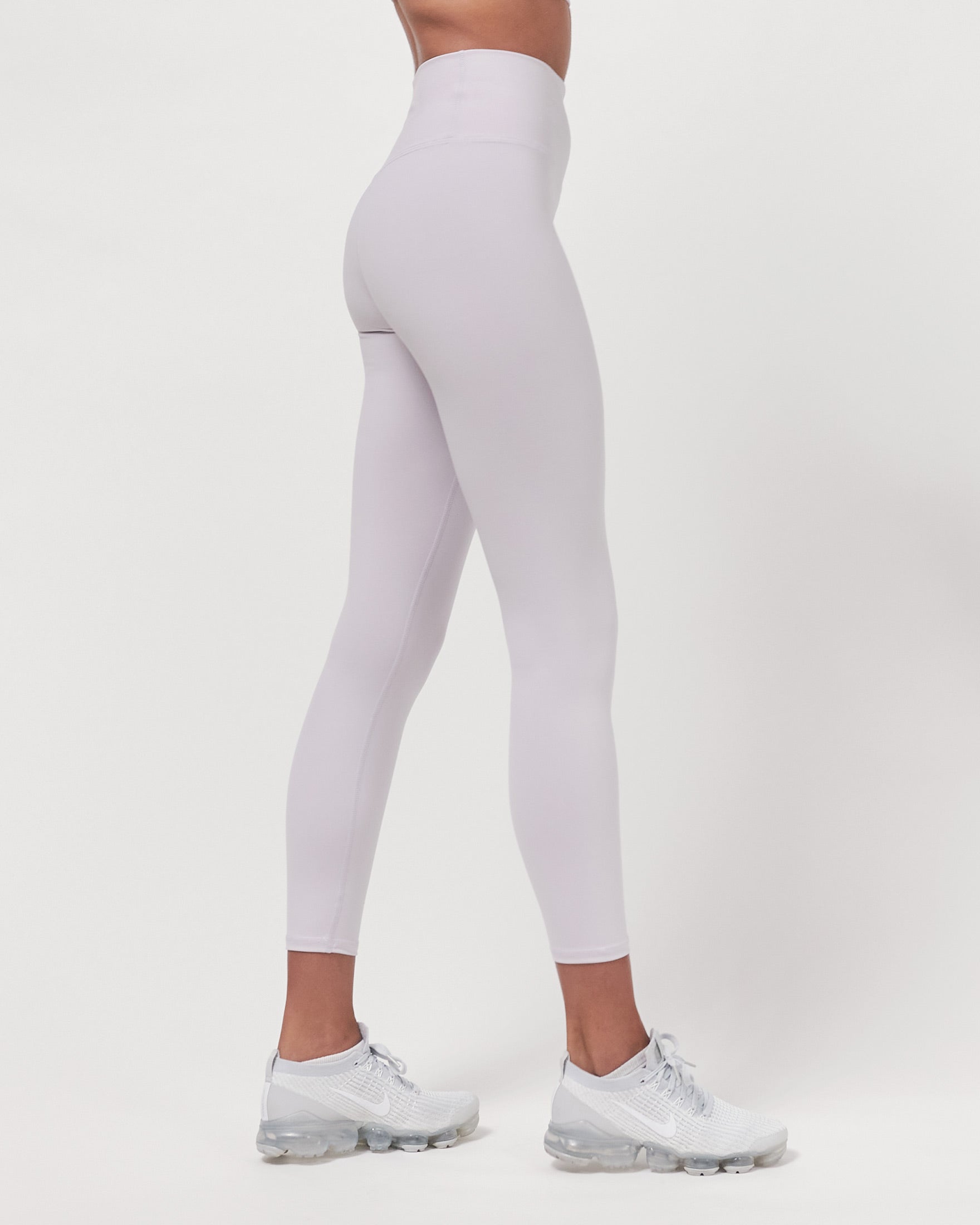 A pair of black Hybrid Cloudlux Leggings with a high waist and seamless design, showcasing V-shaped seams at the back for a flattering fit.