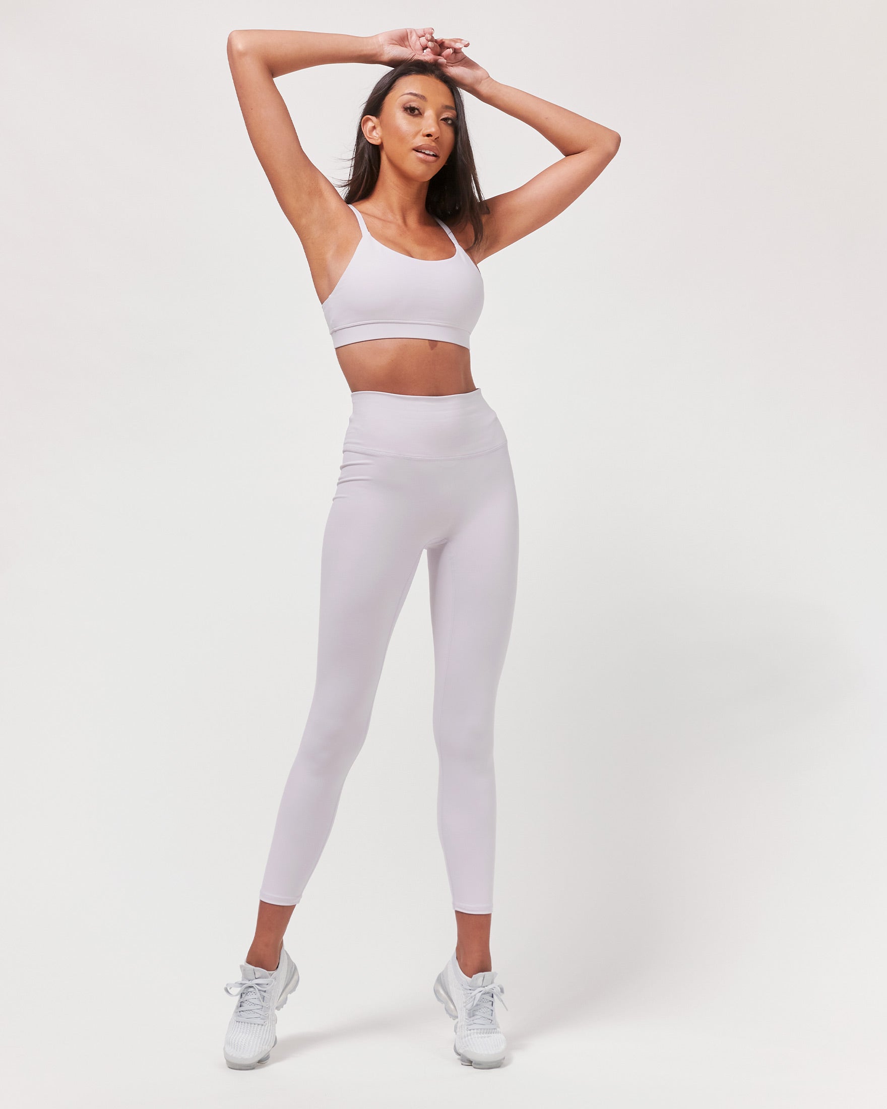 A pair of black Hybrid Cloudlux Leggings with a high waist and seamless design, showcasing V-shaped seams at the back for a flattering fit.