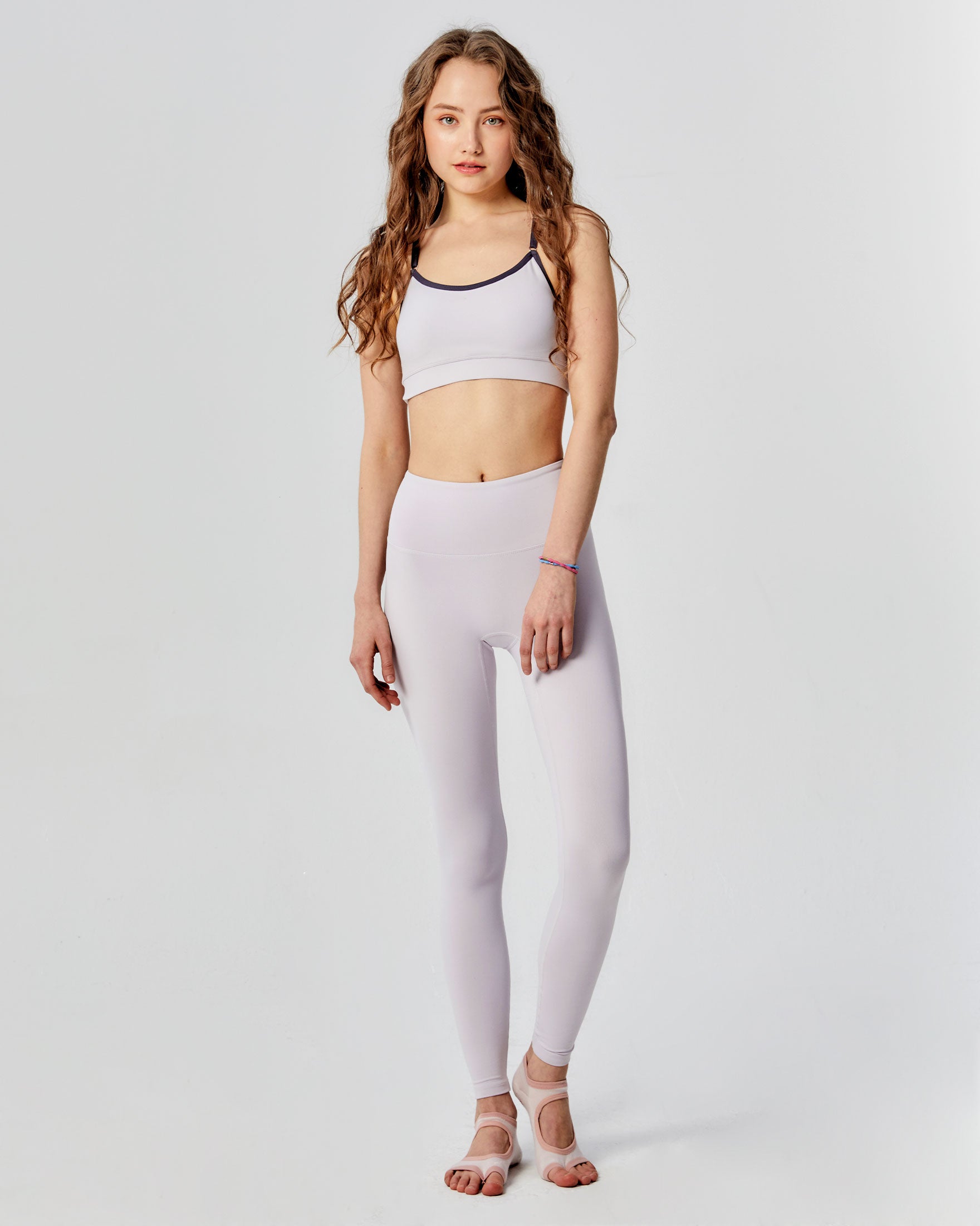 A pair of black Hybrid Cloudlux Leggings with a high waist and seamless design, showcasing V-shaped seams at the back for a flattering fit.