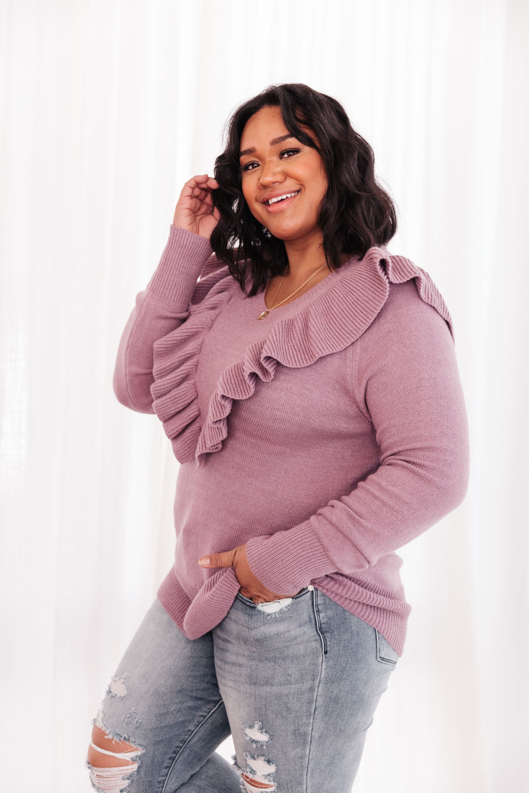 I Choose You Sweater in Purple featuring ruffle v-shaped detail and cuffed wrists, displayed on a model.