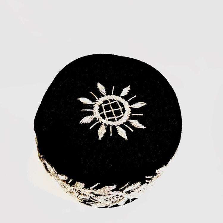 A stylish Igbo cap featuring intricate embroidery-like beading, available in various colors.