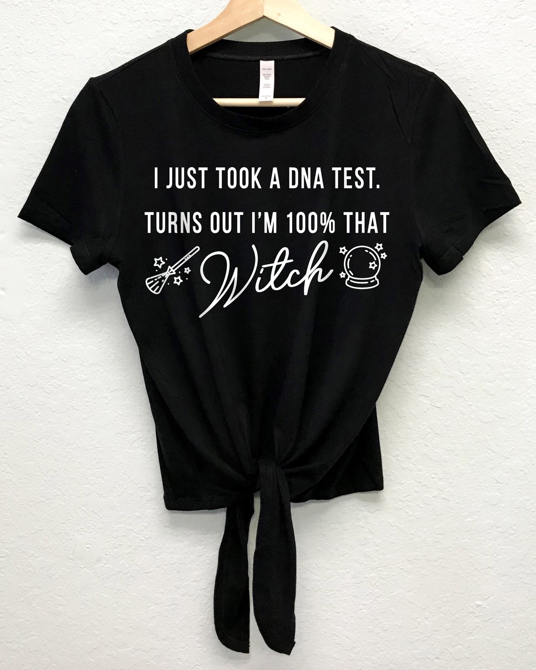 A stylish Halloween shirt featuring the phrase 'I’m 100% That Witch' in bold letters, available in crop top, t-shirt, and sweatshirt styles.