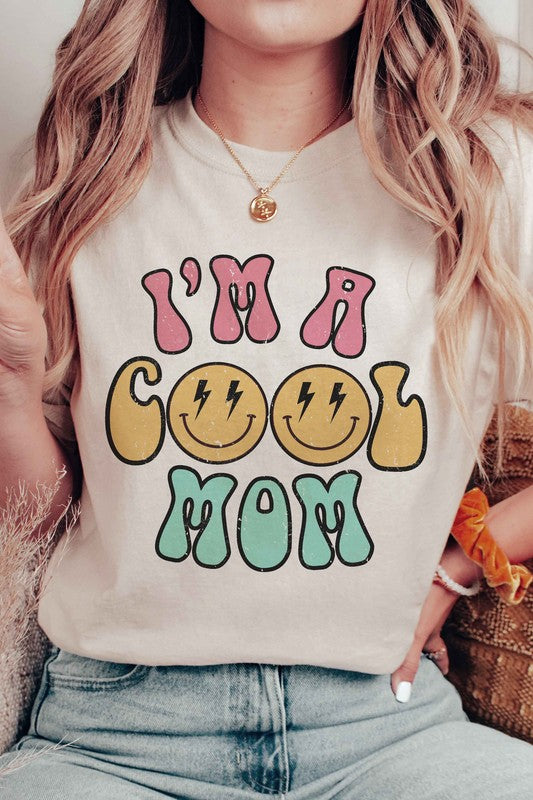 I'M A COOL MOM HAPPY FACE GRAPHIC TEE featuring a cheerful happy face design, made from 100% cotton, available in various sizes.