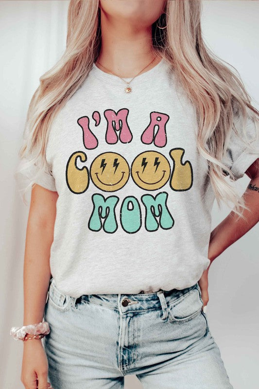 I'M A COOL MOM HAPPY FACE GRAPHIC TEE featuring a cheerful happy face design, made from 100% cotton, available in various sizes.