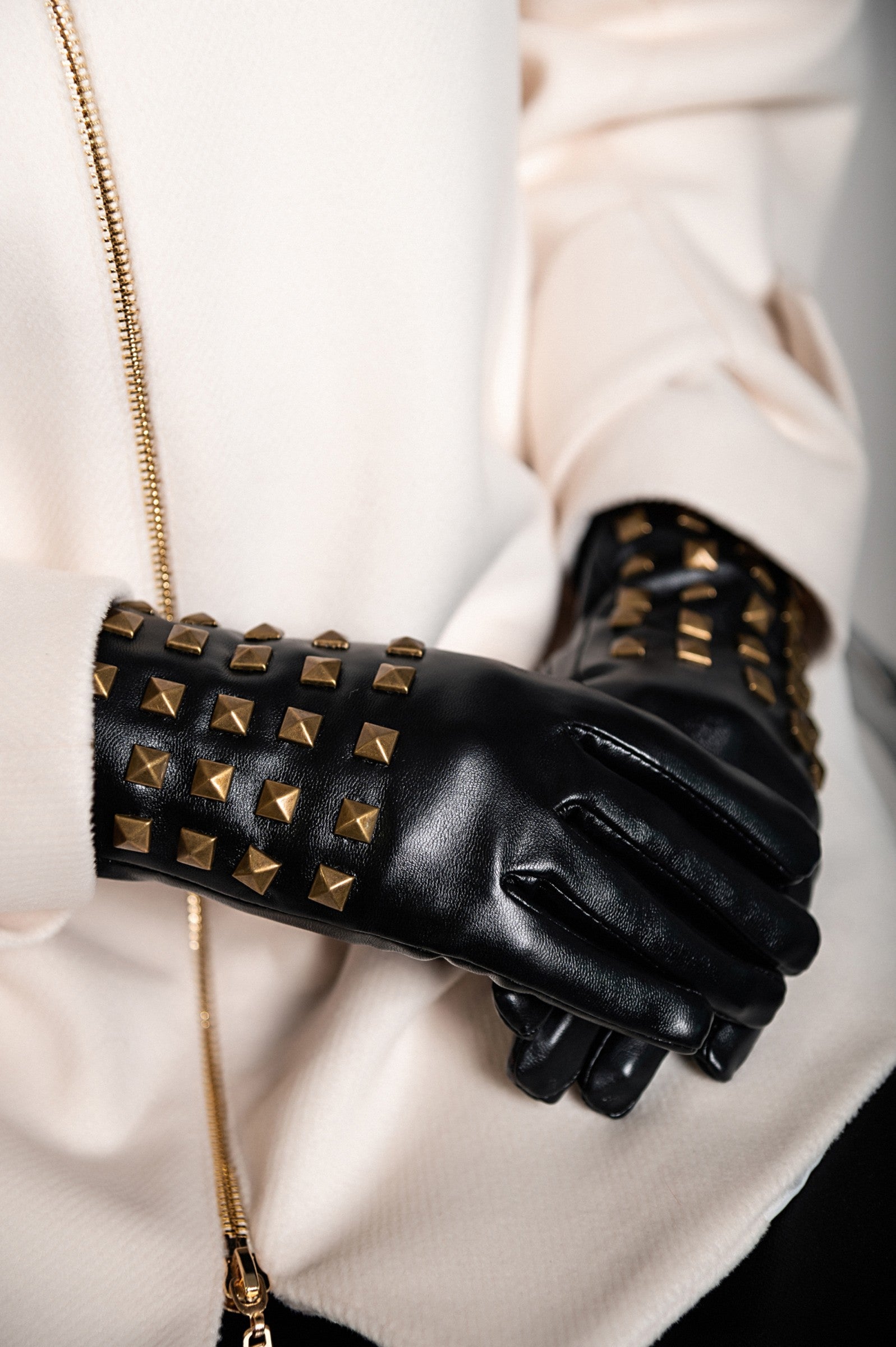 Black imitation leather gloves featuring decorative rivets, showcasing a stylish and warm design.